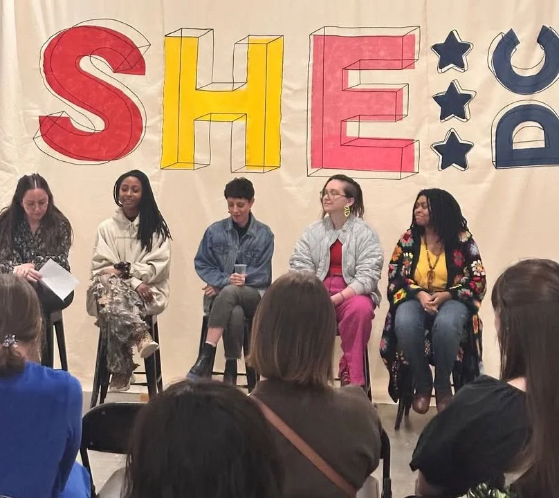 The large canvas banner that I painted with the She DC logo for their March 2025 opening.
