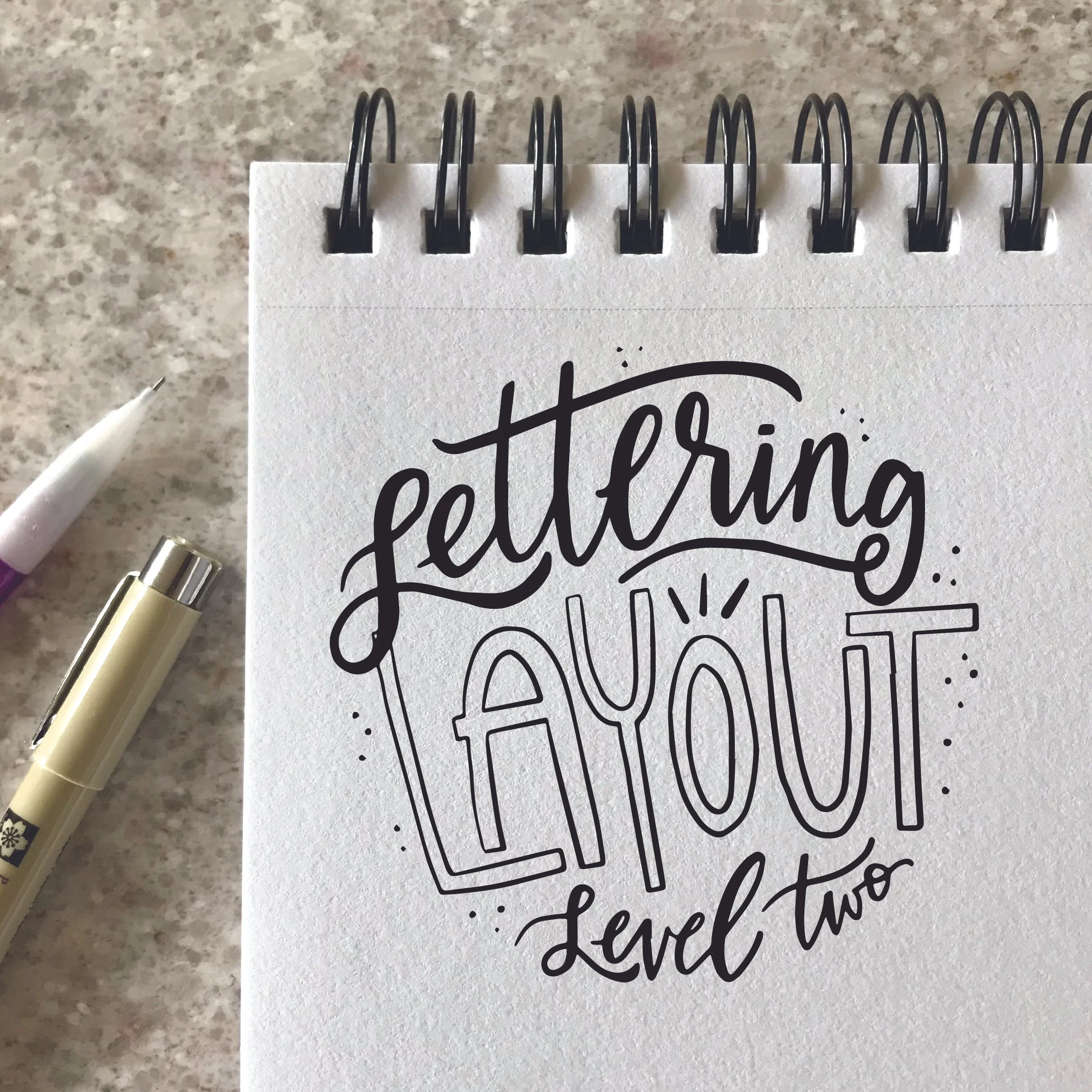 A sketchbook with 'Lettering Layout Level two'