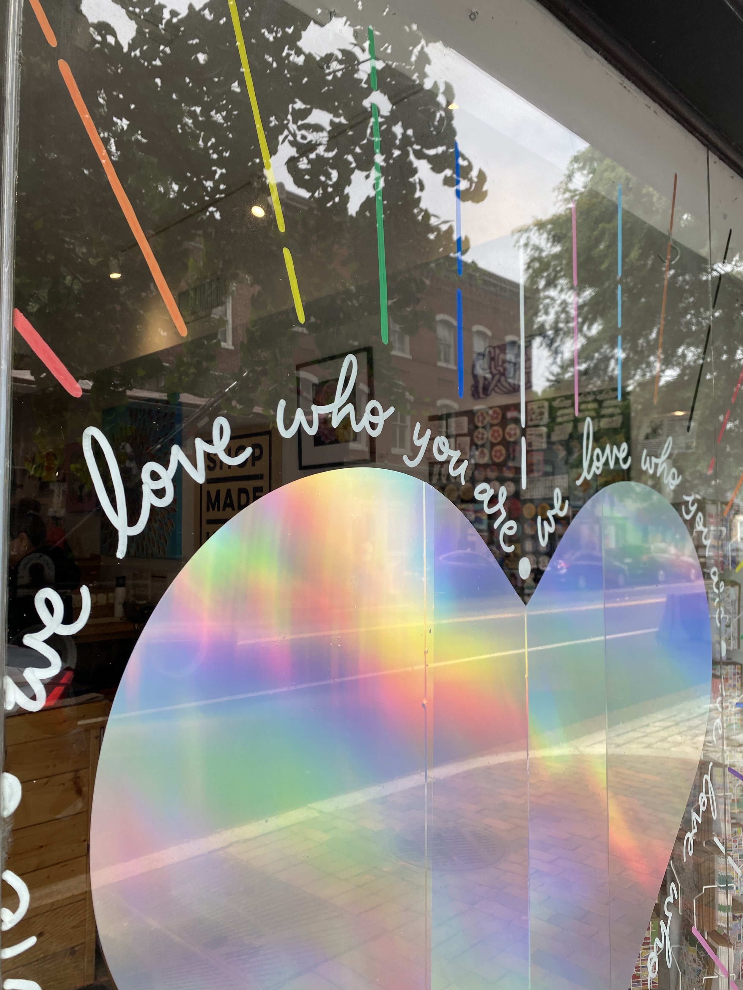A close up of the Pride 2025 window graphics that I designed.
