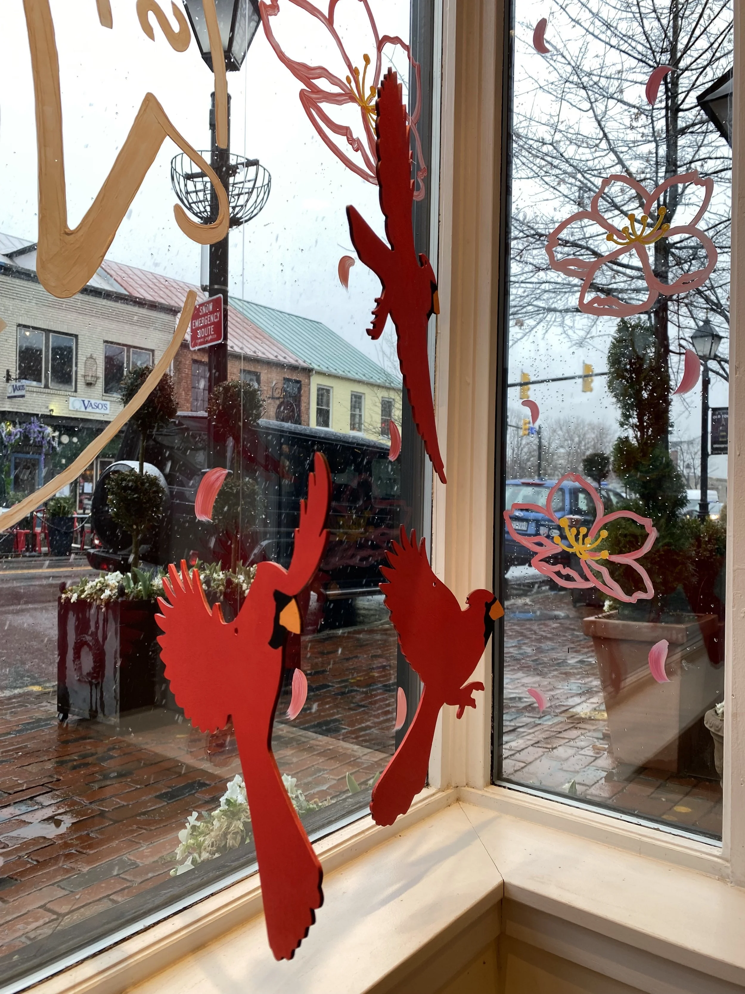 Laser cut and painted cardinals for spring retail window displays.