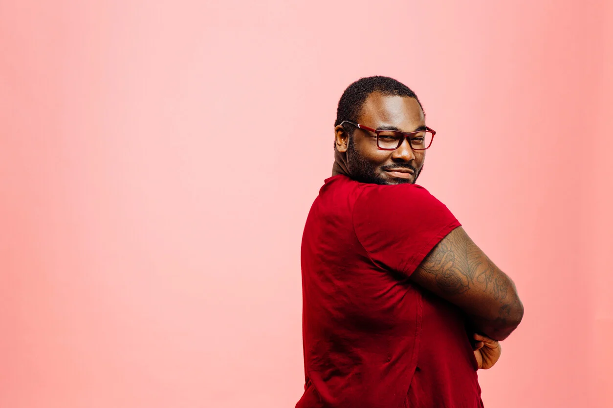 Confidence. Portrait of a confident plus size man in red shirt and glasses looking back at camera - ballroom dance classes concept