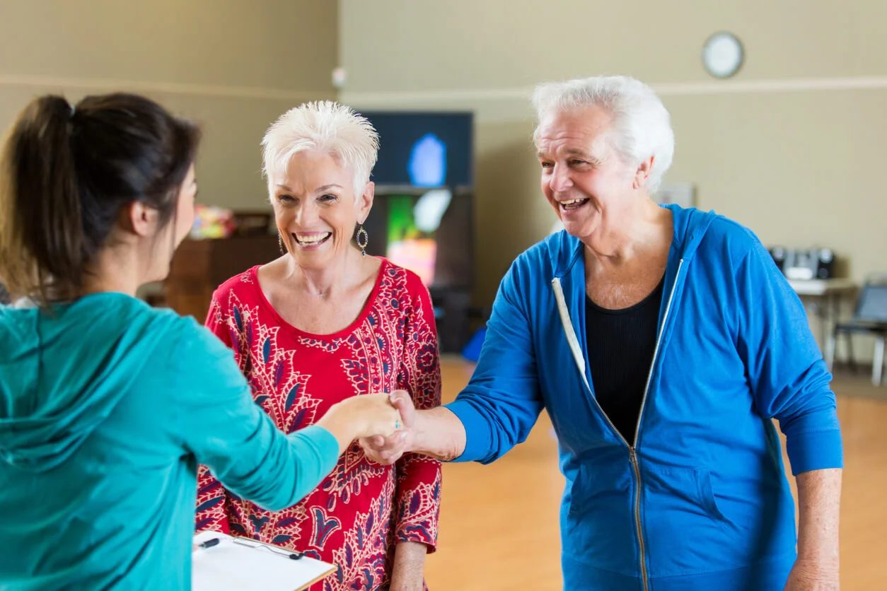 Ballroom Dance Class - Senior couple shake hands with an instructor at their first ballroom dance class