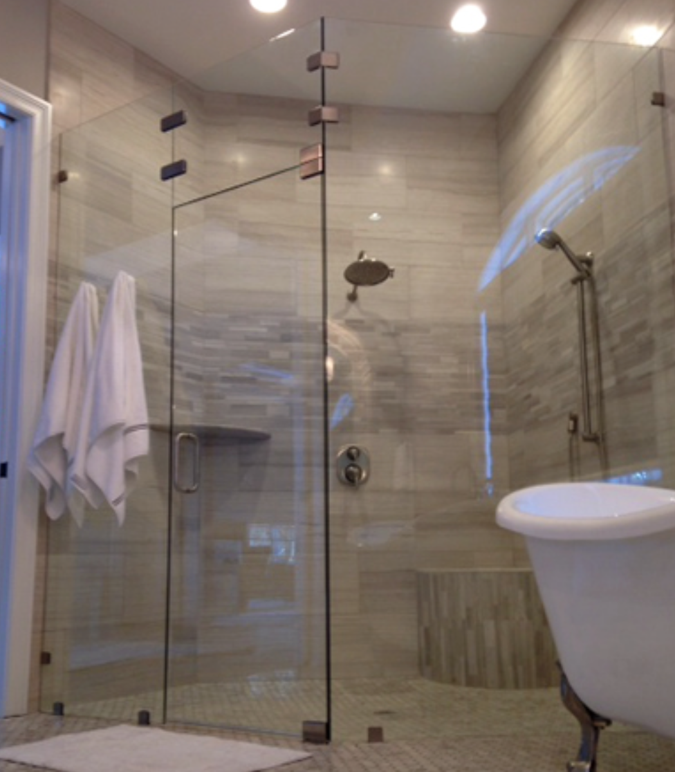 Frameless Heavy Glass Shower Door Probably the style that comes to mind when every person dreams of remodeling their shower. Heavy glass is just that - glass that is heavy enough to support itself without the need to additional metal around it. Notice how completely open this door makes the shower look. Why spend all that money to tile a shower and then hide it with ugly metal. The frameless shower door is still the door by which all other shower doors are judge by. This door has clear glass and brushed nickel clips with in-line hinges. 