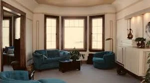 MEHH: This is a great space, however the pieces don't relate to the space. The room needs to be reconfigured to allow the furniture to follow the bow window, You can easily see this in the photo, one option would be to imagine the sofa centered and the club chairs were placed in the middle of the room, creating a conversation area.....all of a sudden that huge gap and feeling of cold would close. I may even choose to open the window up, having it clear to move and walk up to. Creating a seating area more center focused. 