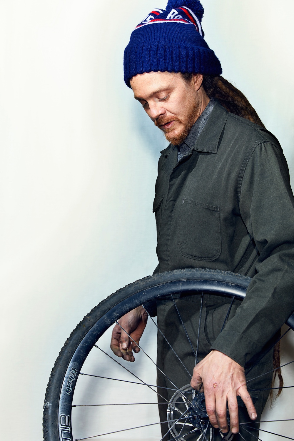 Bike-mechanic-holding-wheel-one-hand.jpg