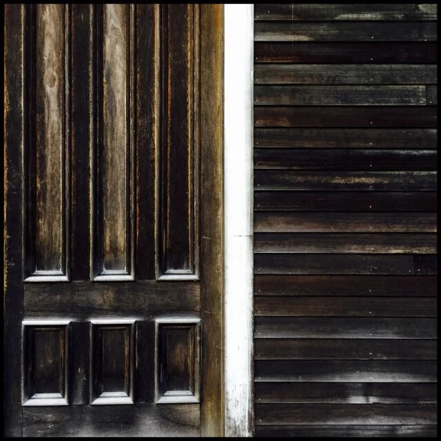 Barn with six-paneled door and clapboards
