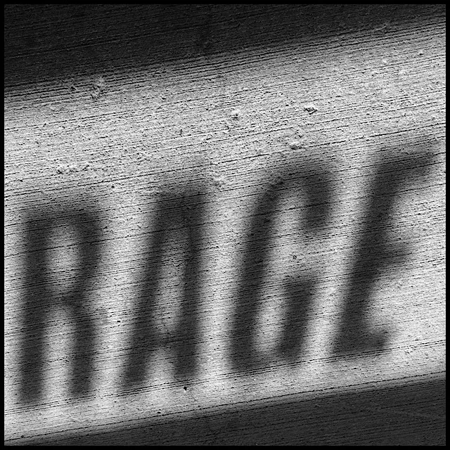 Brushed concrete with shadows from sunlight through lettered glass