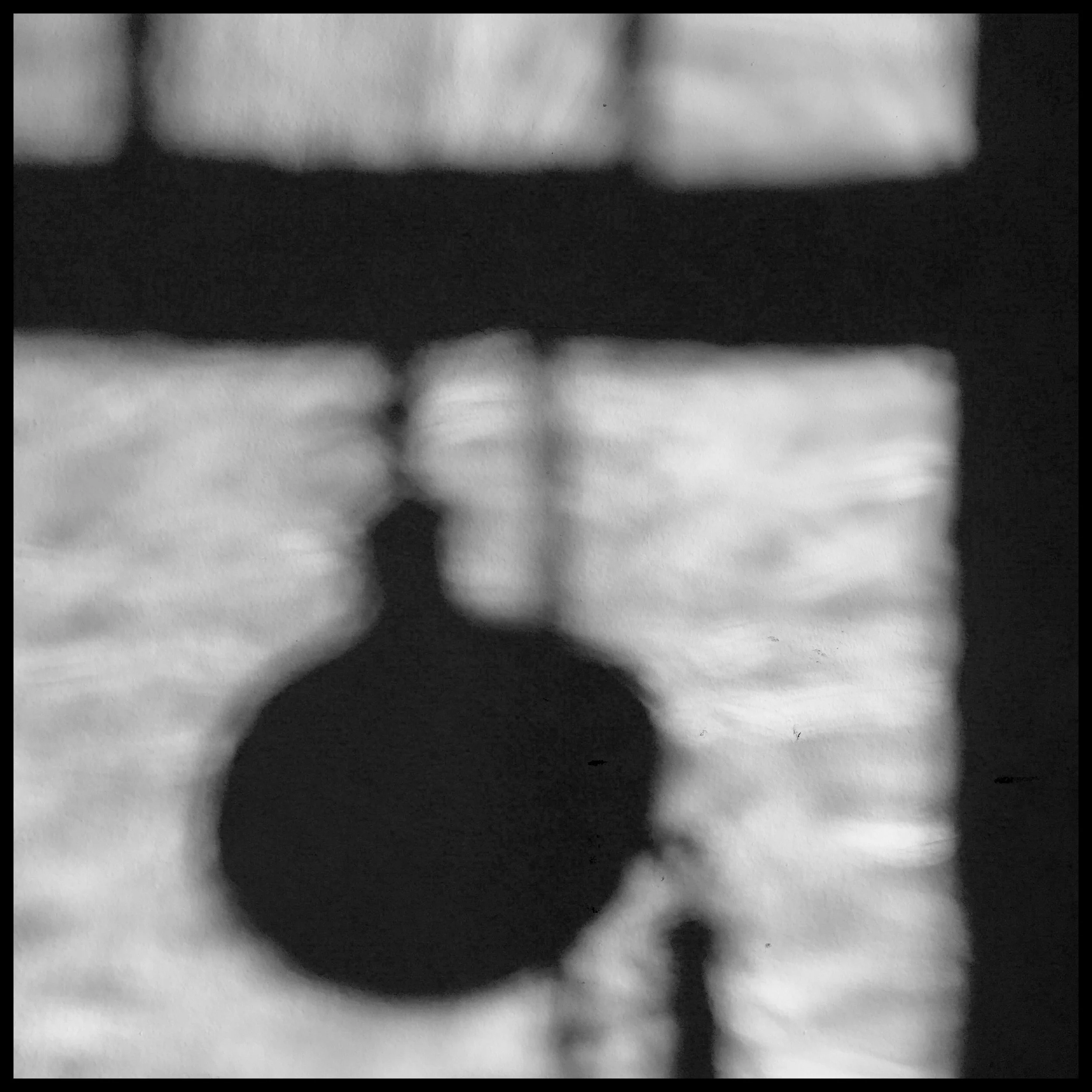 Dawn light casting shadows of glass ripples, window frame, and lamp