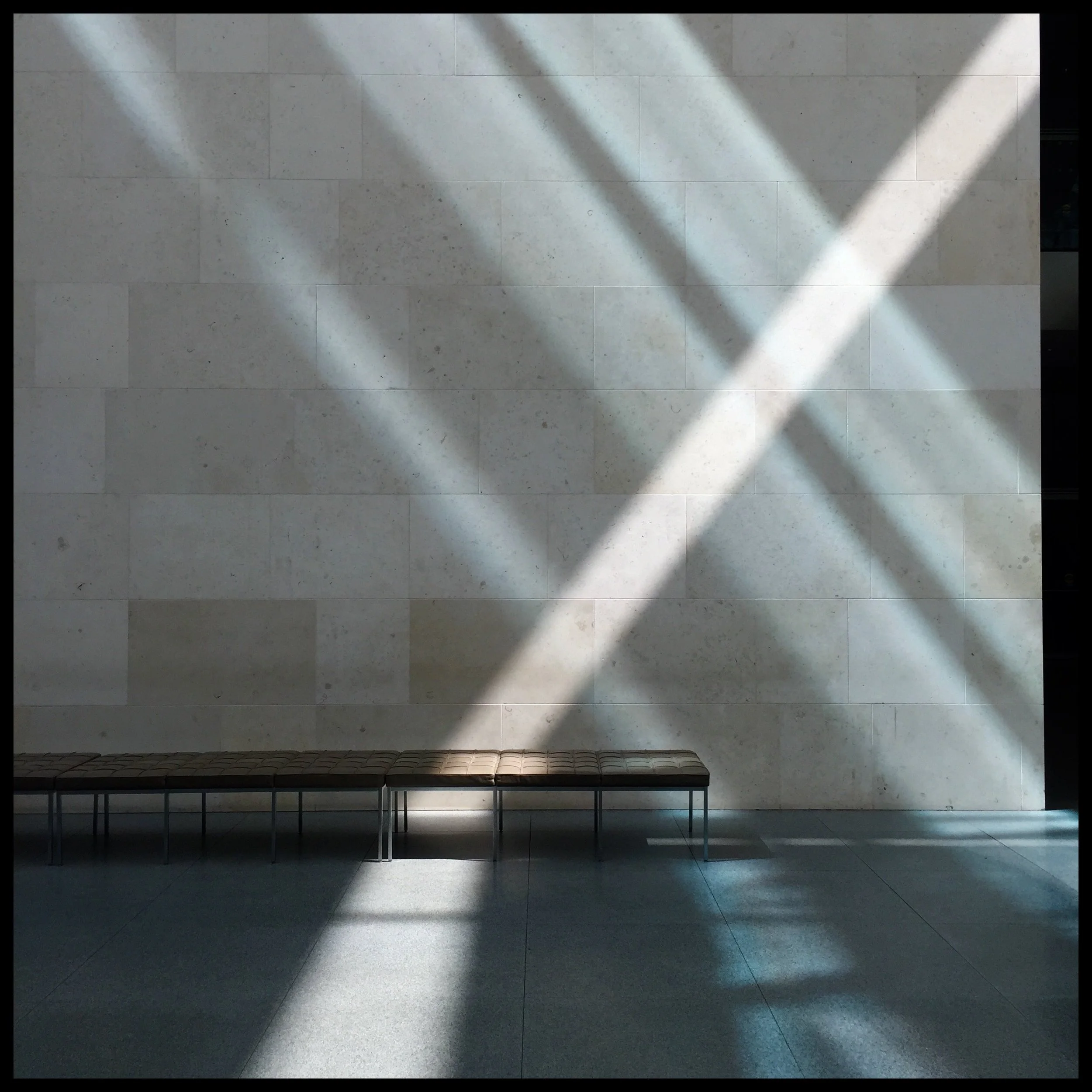Atrium sunlight on wall and bench