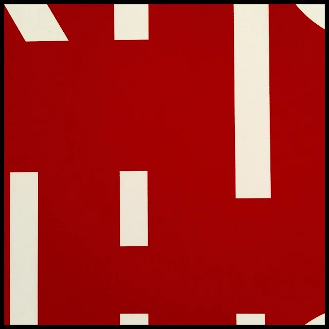 Red space between cropped white letters on signage