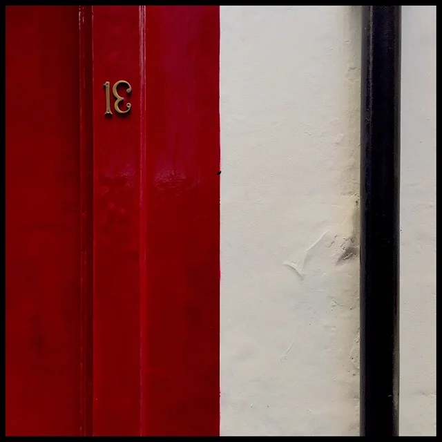 Exterior wall detail in red, white, and black