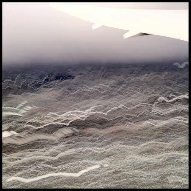 Landscape and horizon under wing during ascent, slow shutter