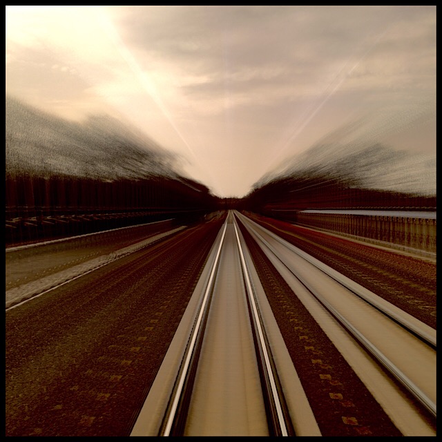 Tracks and trees: rear window view from moving train, slow shutter