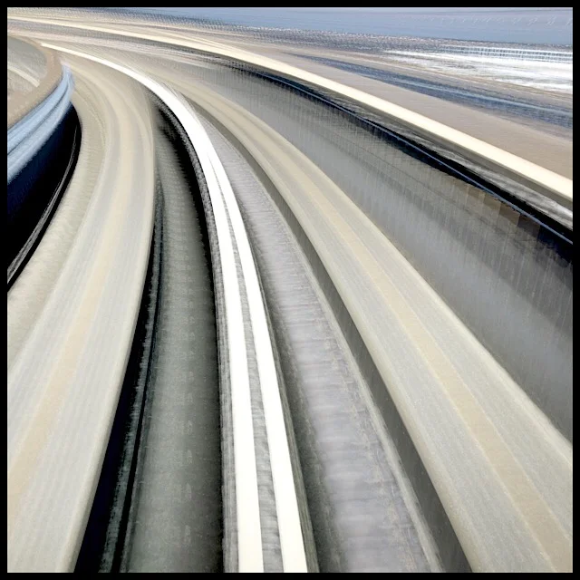 Rounding the curve: rear window view from airport train, slow shutter