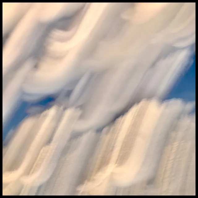 Clouds smeared by yaw and roll of ascending plane, slow shutter