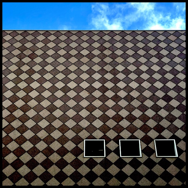 Checkered facade with three windows