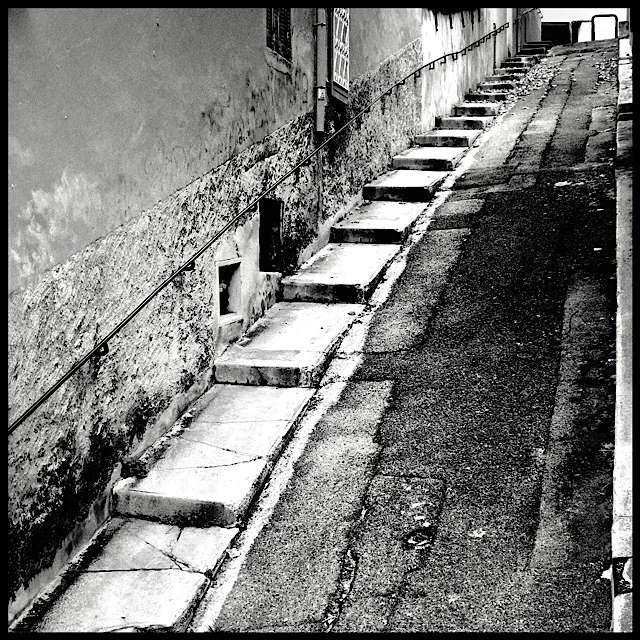 Sidewalk stair with railing on steep street