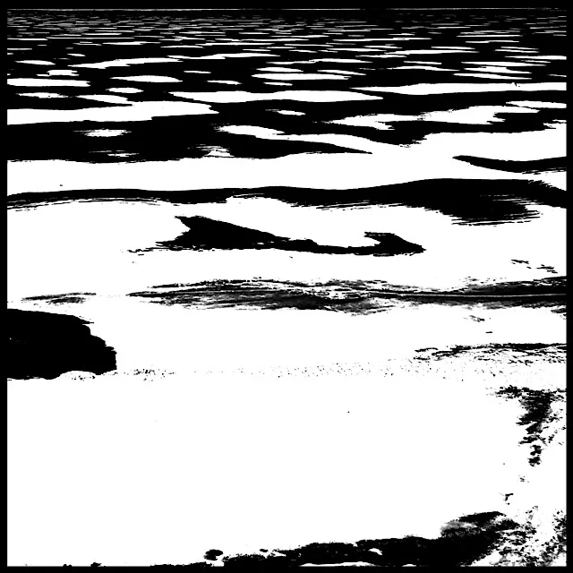 Frozen pond, patchy snow