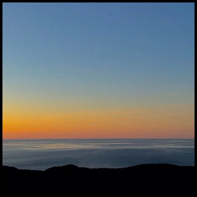 Ocean reflections and ember horizon at sunrise
