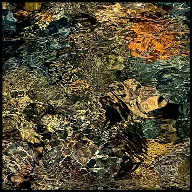 Beach cobbles under rippling snowmelt stream