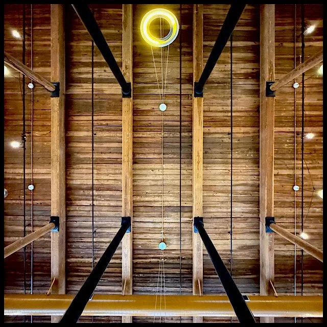 Mill building lobby ceiling with four black posts