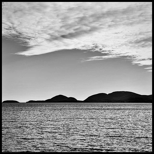 Gentle mountains under jagged clouds