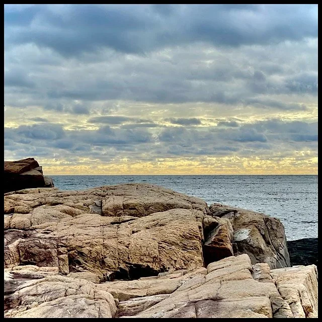 Dark and light rocks with yellow and blue horizon