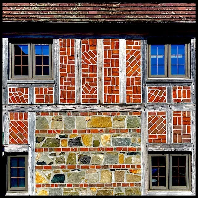 Brick and stone façade with four windows