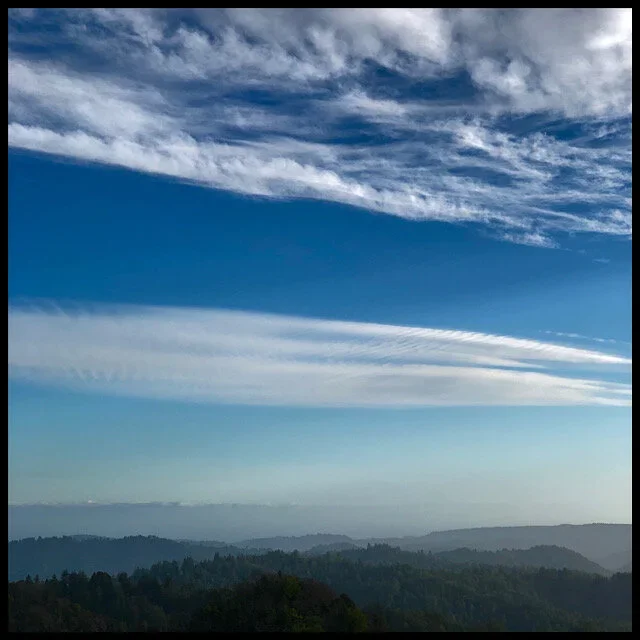 Hazy mountains and layered clouds