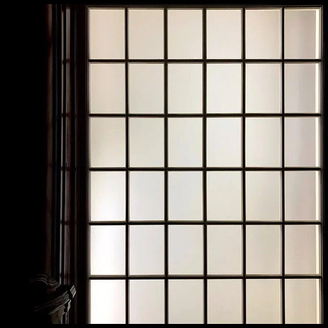 Dark interior with thirty-six panes of diffused daylight