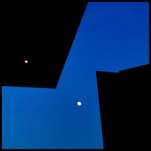 Moon sky between cantilevered roof and silhouetted sculpture
