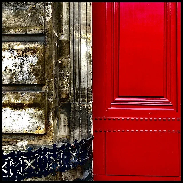 Weathered wall, wrought iron, red gate door