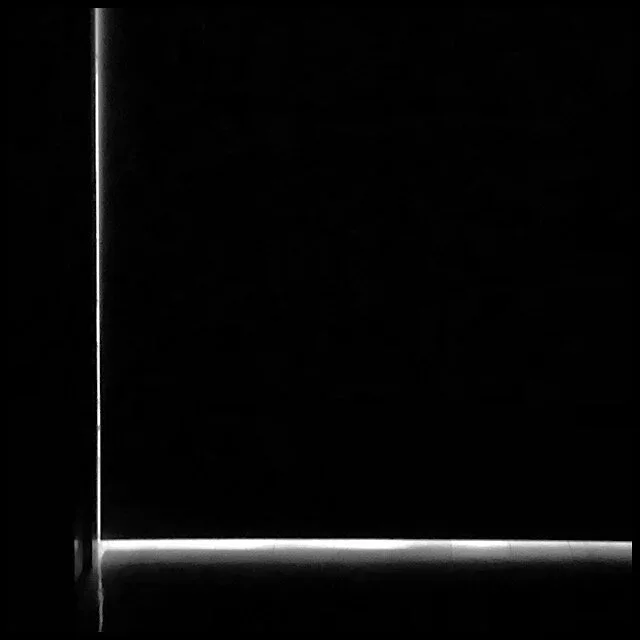 Backlit door in dark hallway
