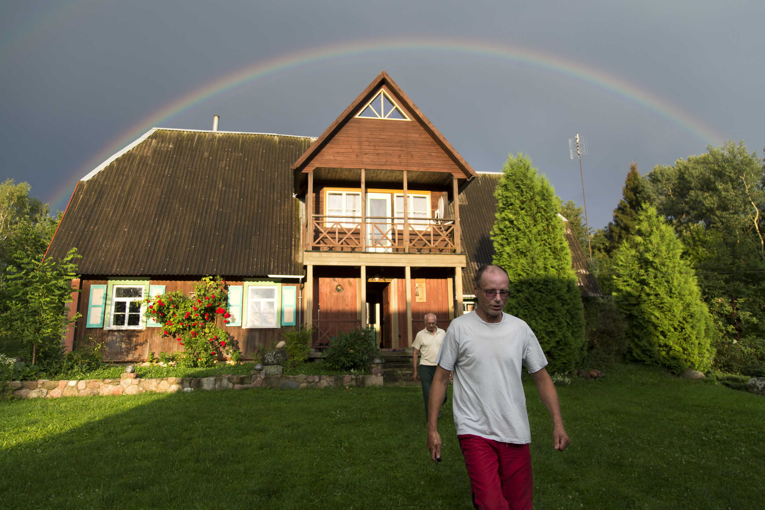 Marius Kalade, 52, and Julius Kalade, 78, walk outside to view the rainbow over my grandfather's house. My father has been living with my grandfather for almost 6 years. We call the property "Fazenda," after the Spanish word for estate, "hacienda."