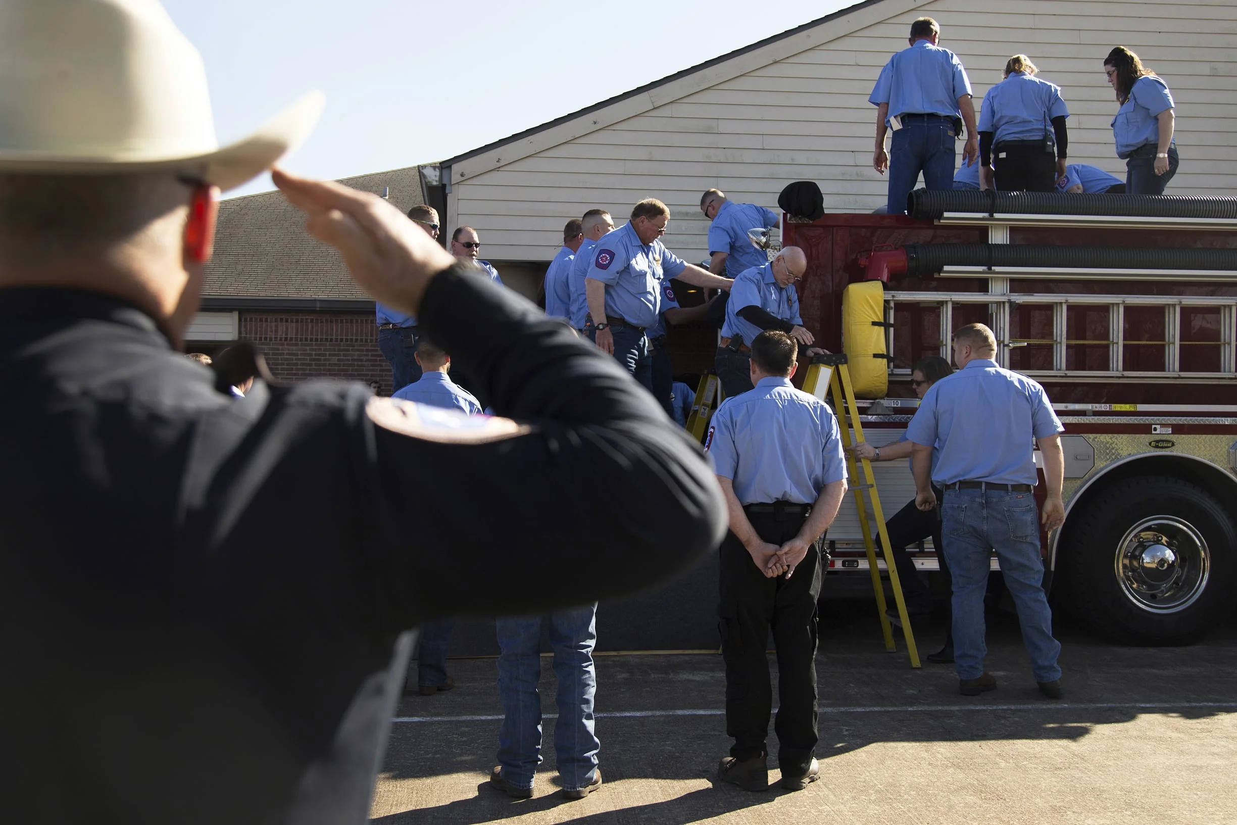 Henry's casket is loaded onto a firetruck outside the Oaklawn Funeral Home Chapel in Edna, TX.