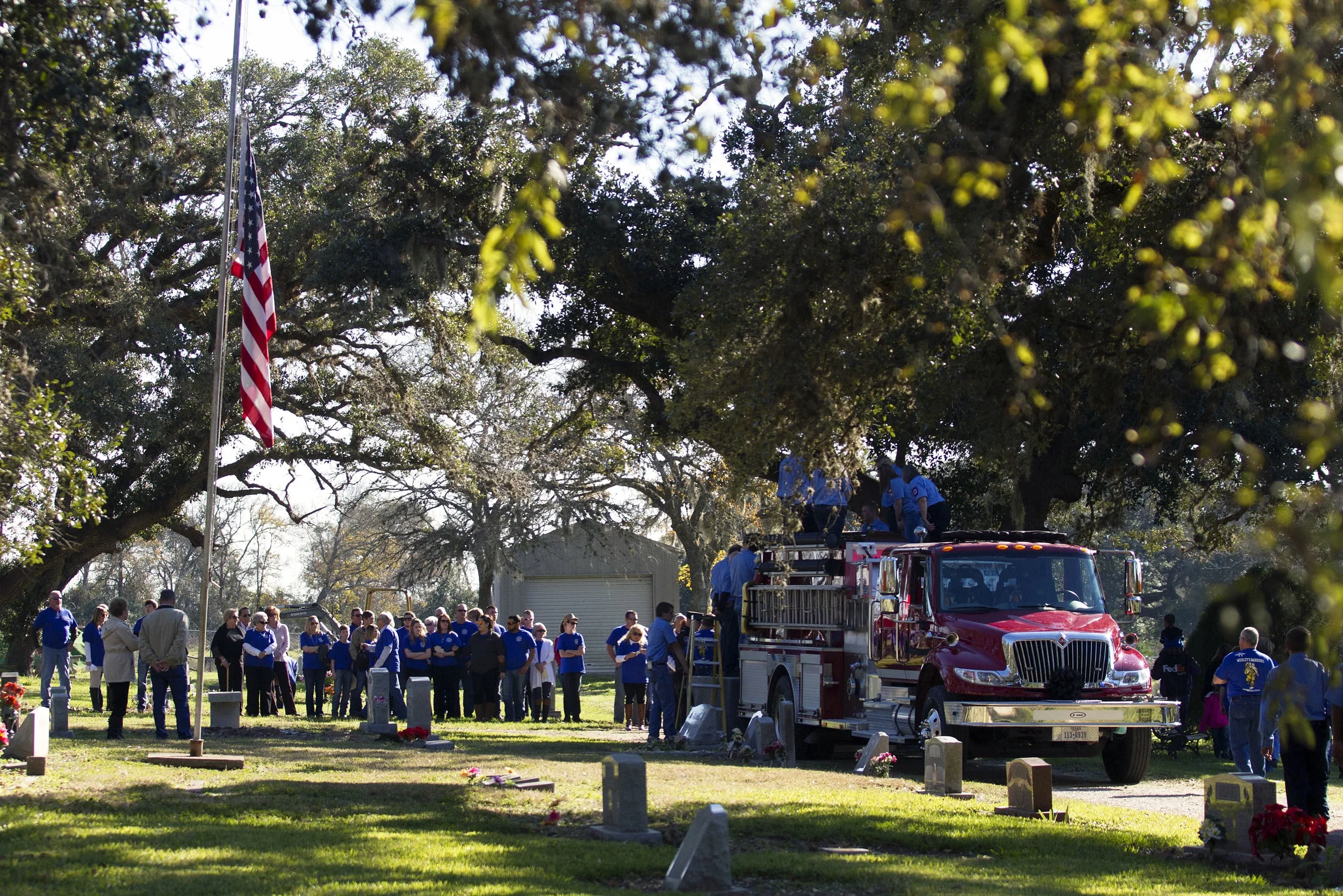 Henry's casket is unloaded from a firetruck at Red Bluff Cemetery in Lolita, TX.