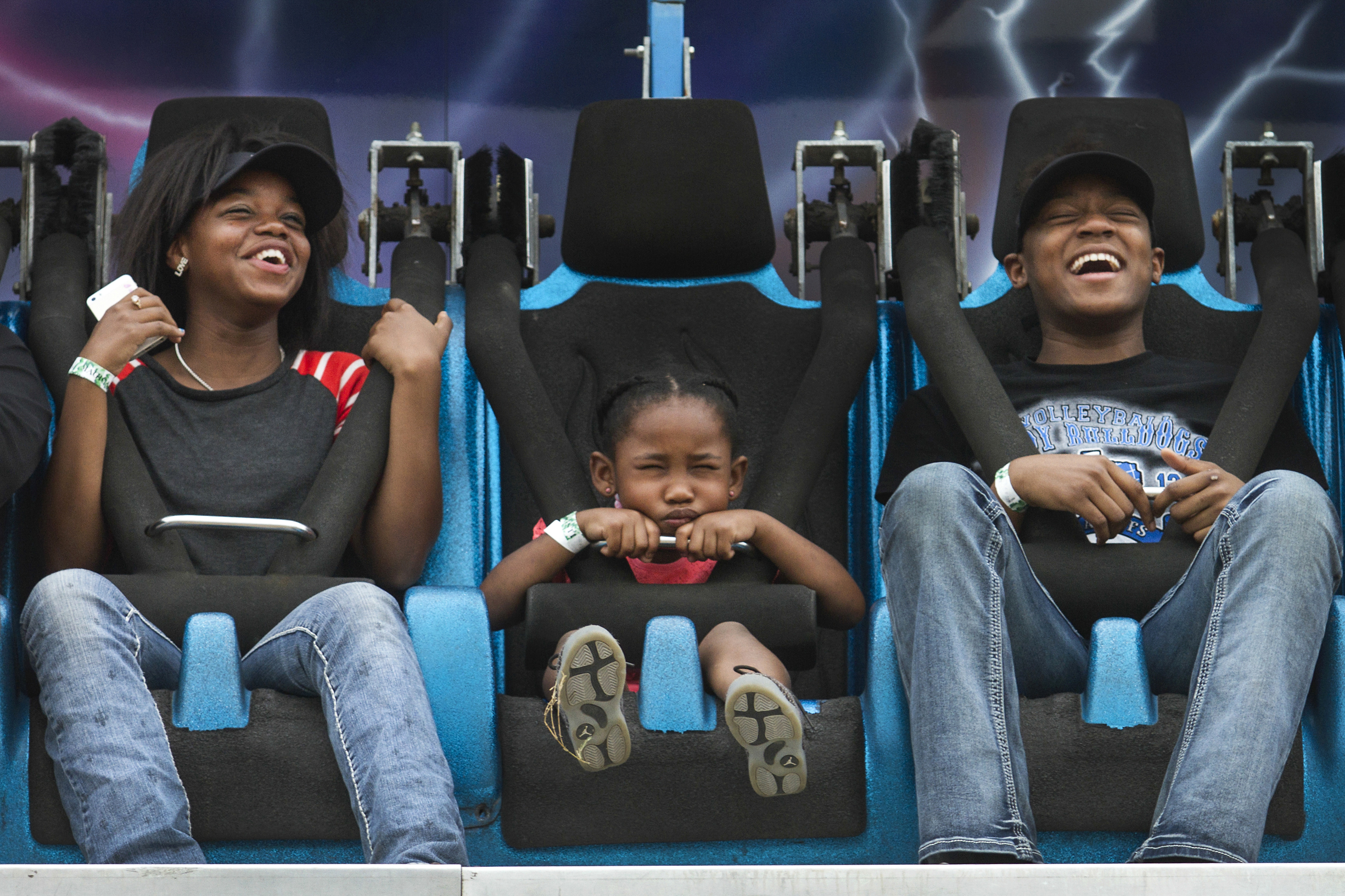 Charisma Thomas, 14, left, Amiyah Burton, 4, center, and Rashel Bonds, 15, ride "Genesis" at the Livestock Carnival on Sunday, February 21, 2016 in Victoria, Texas. "I never want to go on that ride again. It hurt my tummy," said Burton.