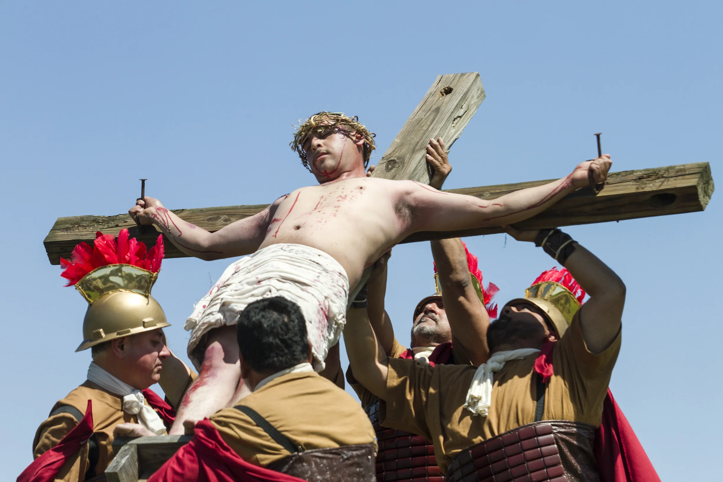 Godinez is lowered with the cross.