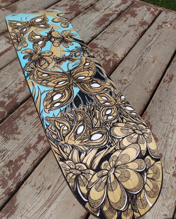 Closeup of  work in process hand painted skateboard custom graphic. 