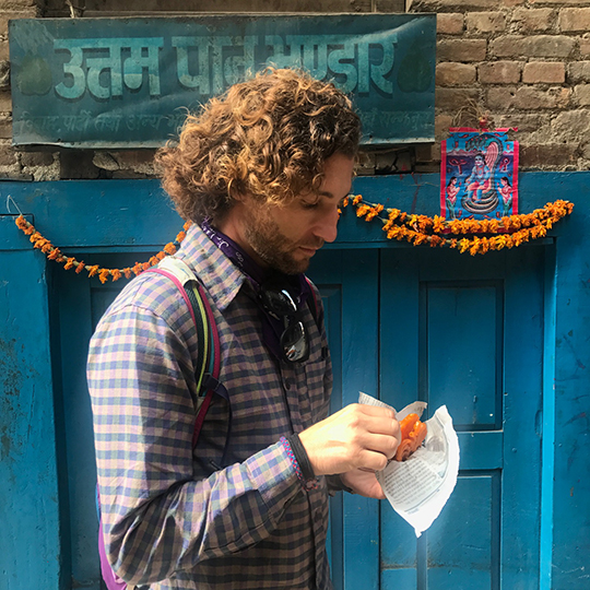 Kaspar eating a sweet jalebi