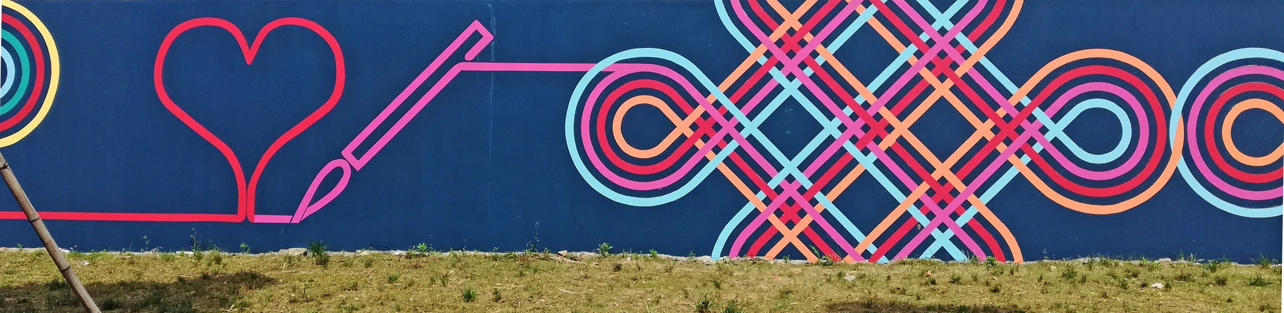 The Arts, represented by a brush painting a heart and flowing into the traditional endless knot