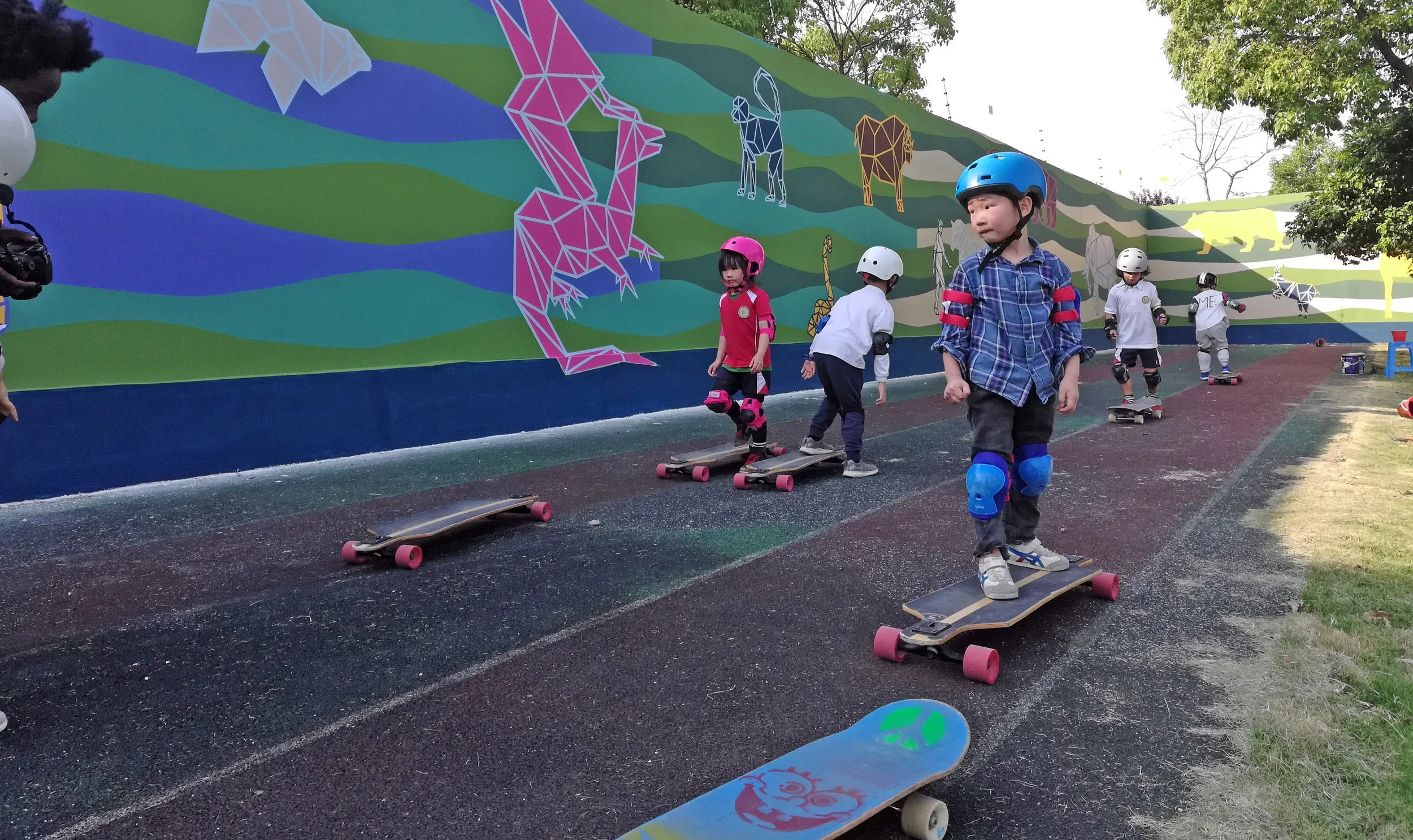 Kids skating in front of the mural.