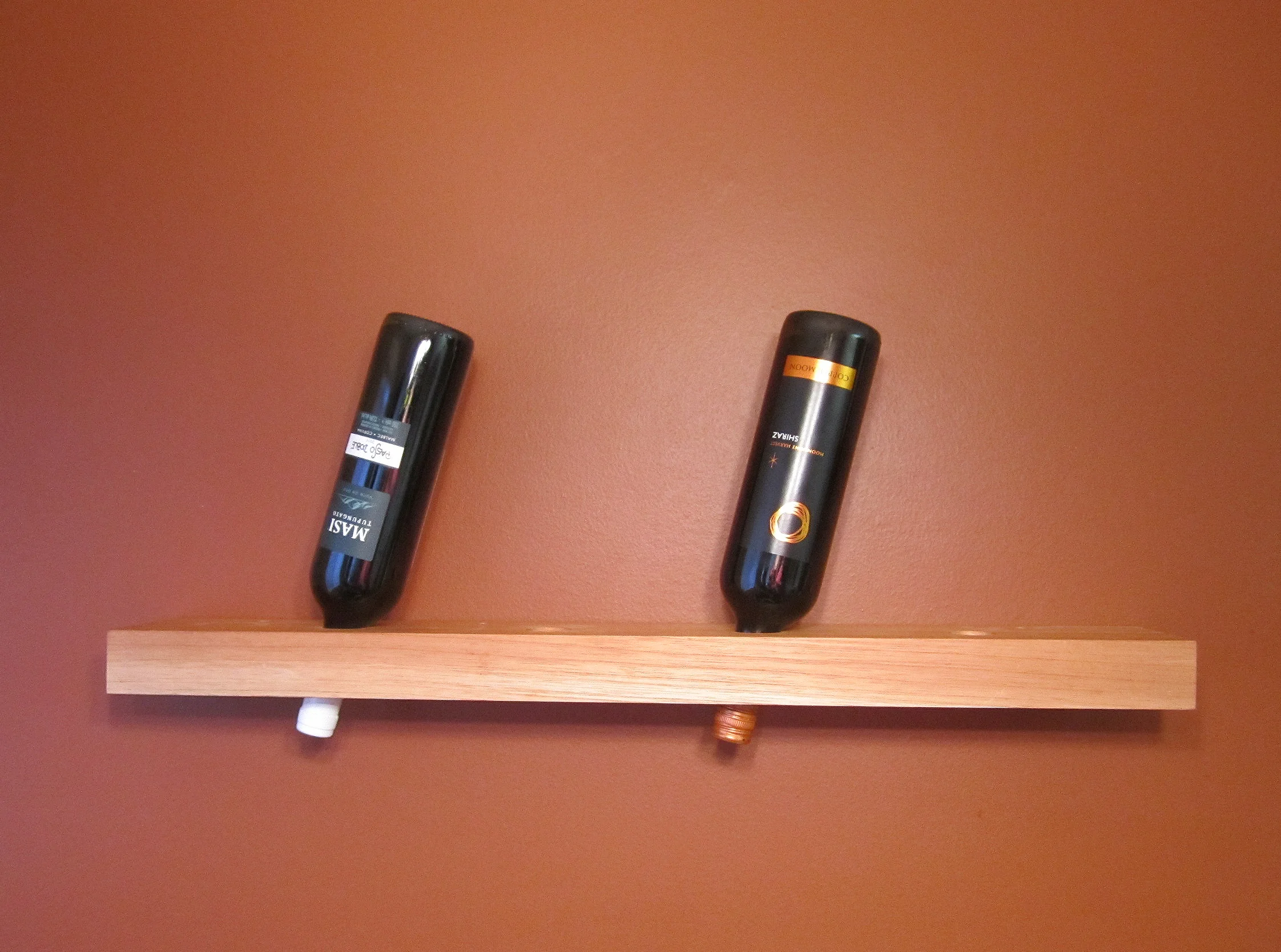 A wine rack made of Spanish Cedar where I also fabricated the metal mounting bracket the wooden component hangs from. 