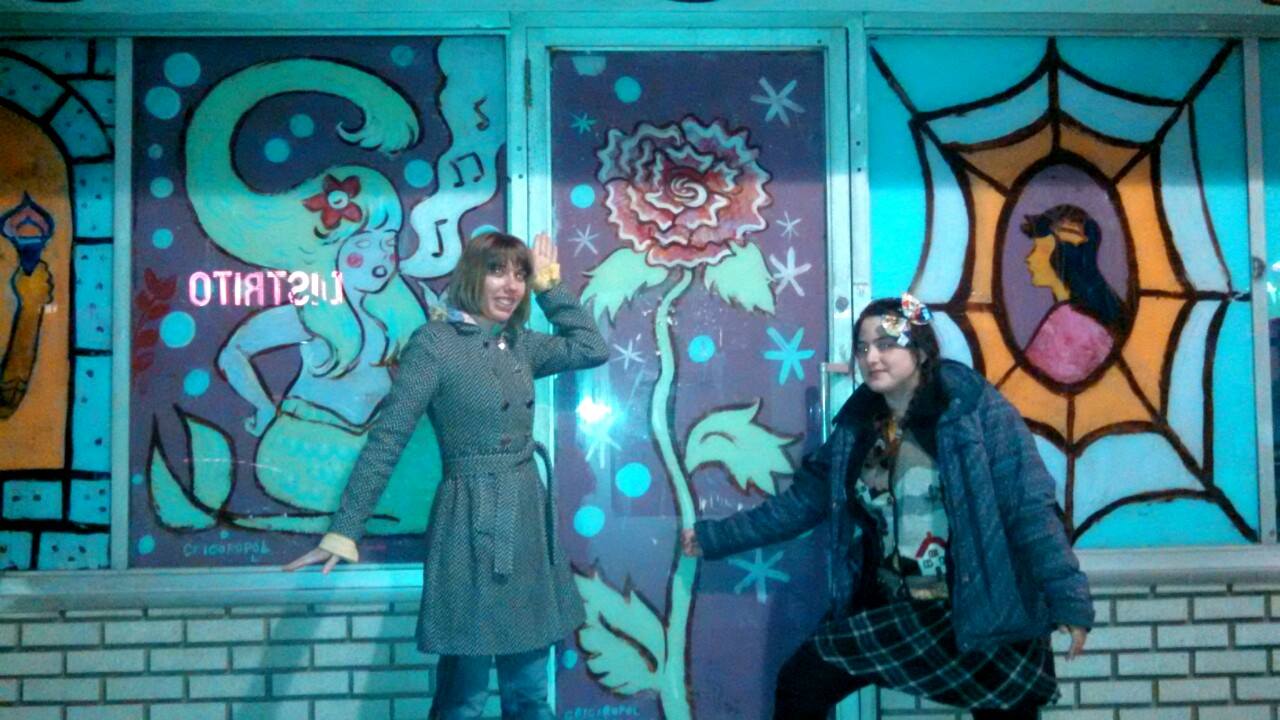 Dre Grigoropol (right) and her mural outside Locust Moon Comics, with Mindy Indy.