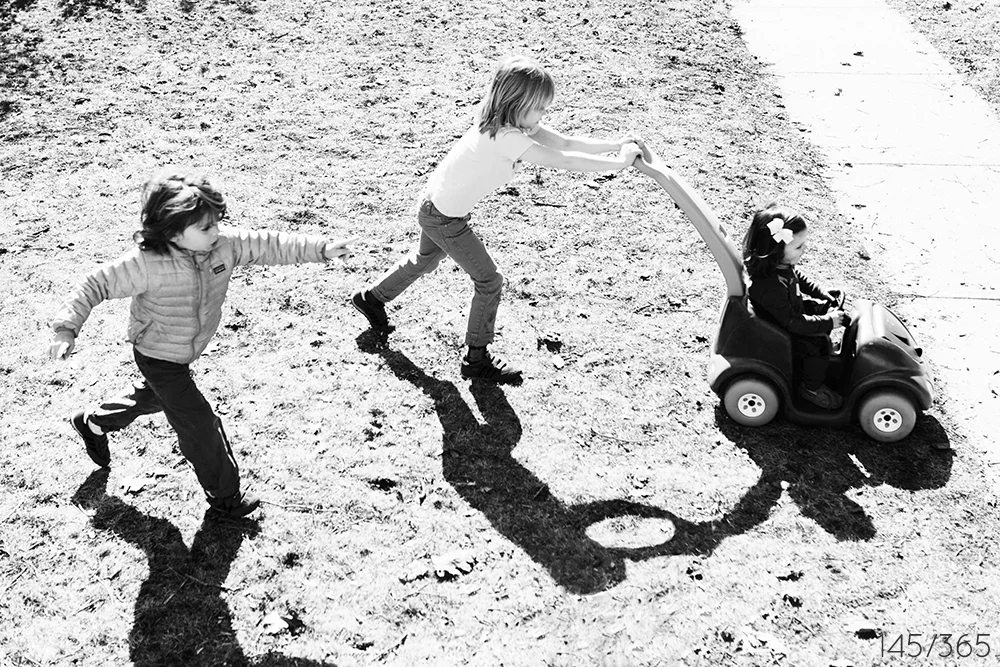 Pushing your cousin in the bright morning sun. Round and round!