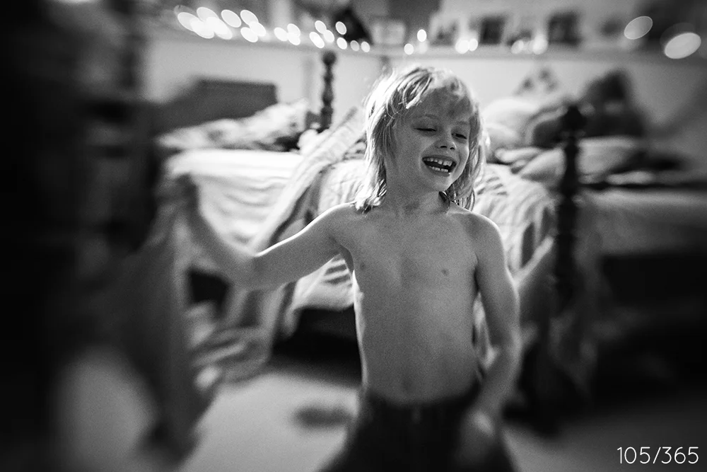 Getting dressed for school, about to toss your pajama top into the laundry. I heard you all giggling so I ran downstairs with my camera to see the big smiles. 