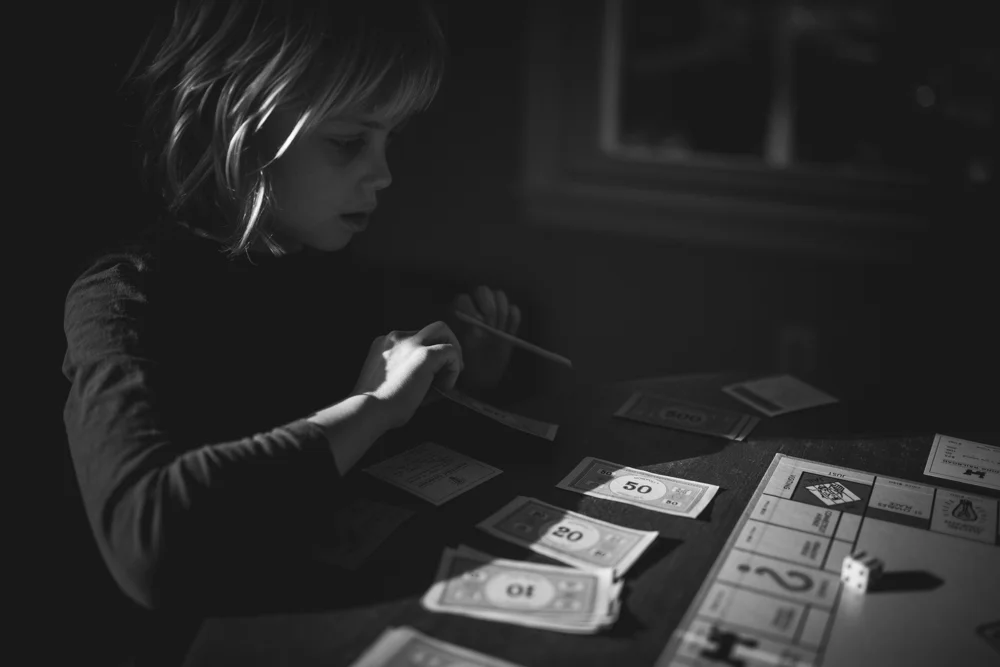 1.2.15 | You wanted to play Monopoly again right after breakfast. Daddy won again despite yours and my own best efforts. It was another quiet day at home on winter break, you didn't really want to go anywhere. We talked about an outing to Portland, but you wanted to stay home, and I had a headache. The funniest moment was when you came in to tell me that you spied on the trash lady, from a new tree you learned to climb. I was on the phone with Camille, whom I really hope you will meet one day. f 1.4 | ISO 400 | 35mm | 1/4000