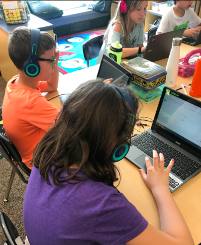 Third graders enjoy the new BSCO purchased headphones.