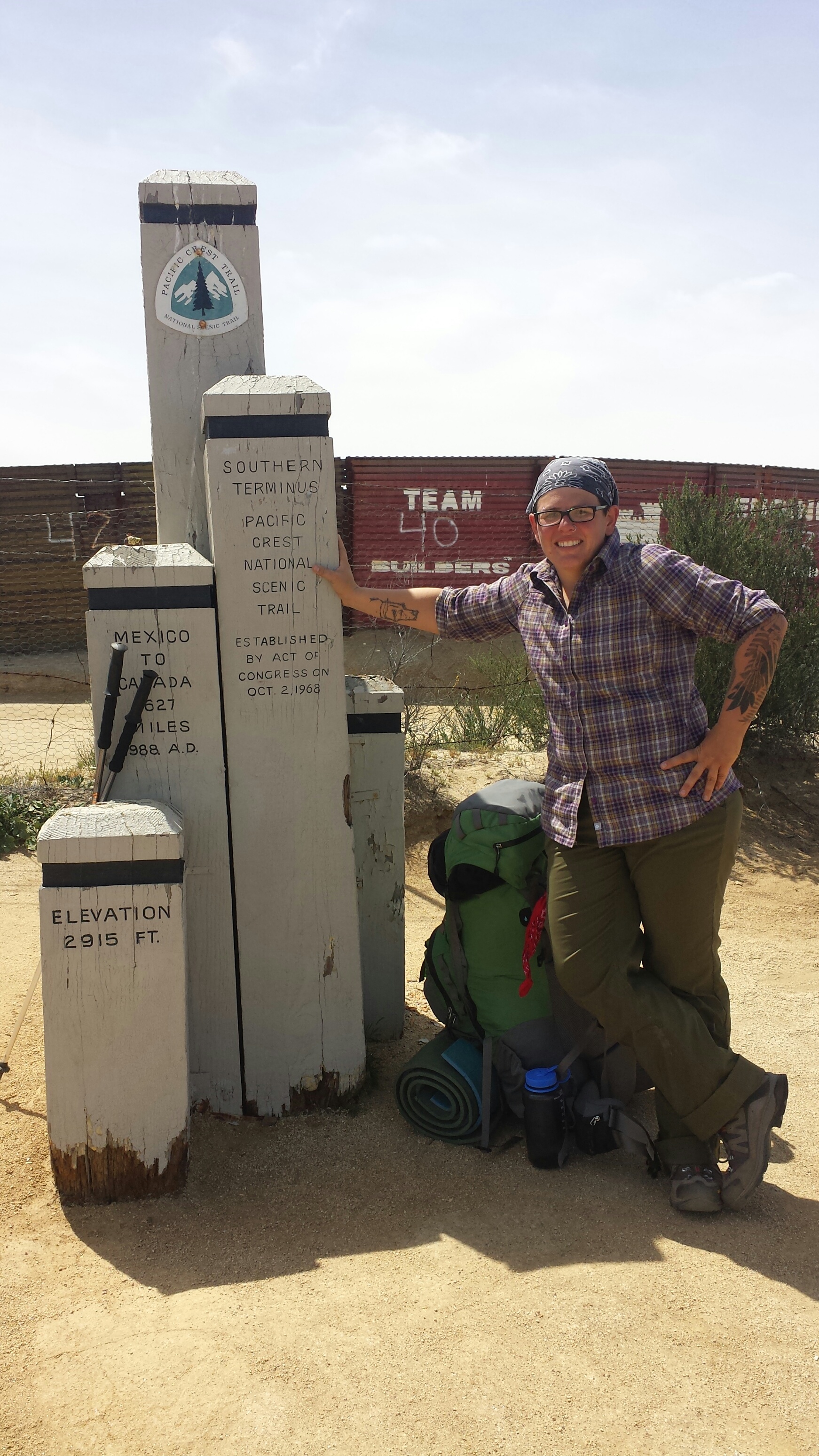 Carsick at the Southern Terminus. Standing too close to the border fence for my liking.