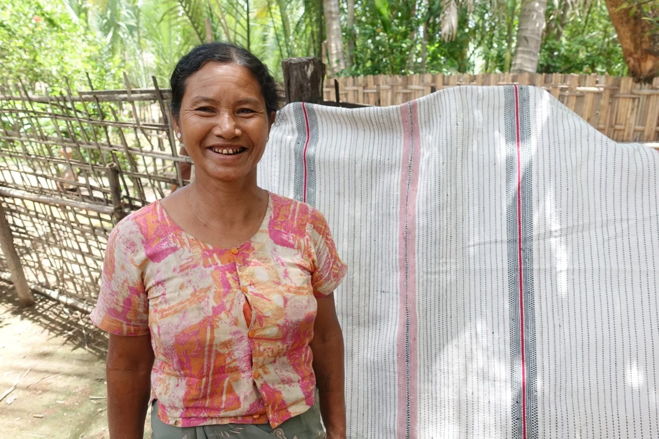 Khine Ma Pyu it is not possible to summarize Khine Ma Pyu. She might be sharp as a tack, busy as a bee, strong as an ox, and funny as hell but there are no clichés which can hold her —Khine Ma Pyu is a force of nature. Constantly in motion Pyu loves to laugh, to dance, to sing, to freestyle; she walks fast, and shops shrewdly. She holds legendary dinner parties at the river’s edge home she shares with her husband, their three teenage daughters, a flock of chickens, and a pair of dogs. You get to their home by way of a floating bridge made with amazingly thick and broad palm petioles (the stalk that joins a leaf to a stem), once there, Pyu might offer you some salty palm fruit leather or maybe she’ll take her machete into the river to hack off some fresh palm fruit. With Craft Talk, Khine Ma Pyu works as a weaving prototype developer, as she’s a quick study, a weaving machine, and a natural communicator.